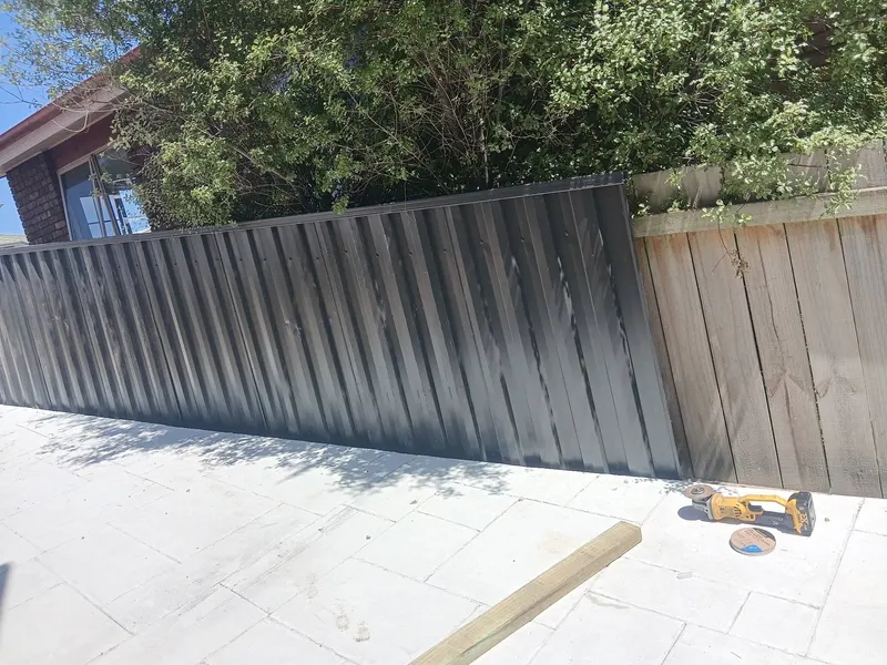 Colorbond fence finished on a paved courtyard