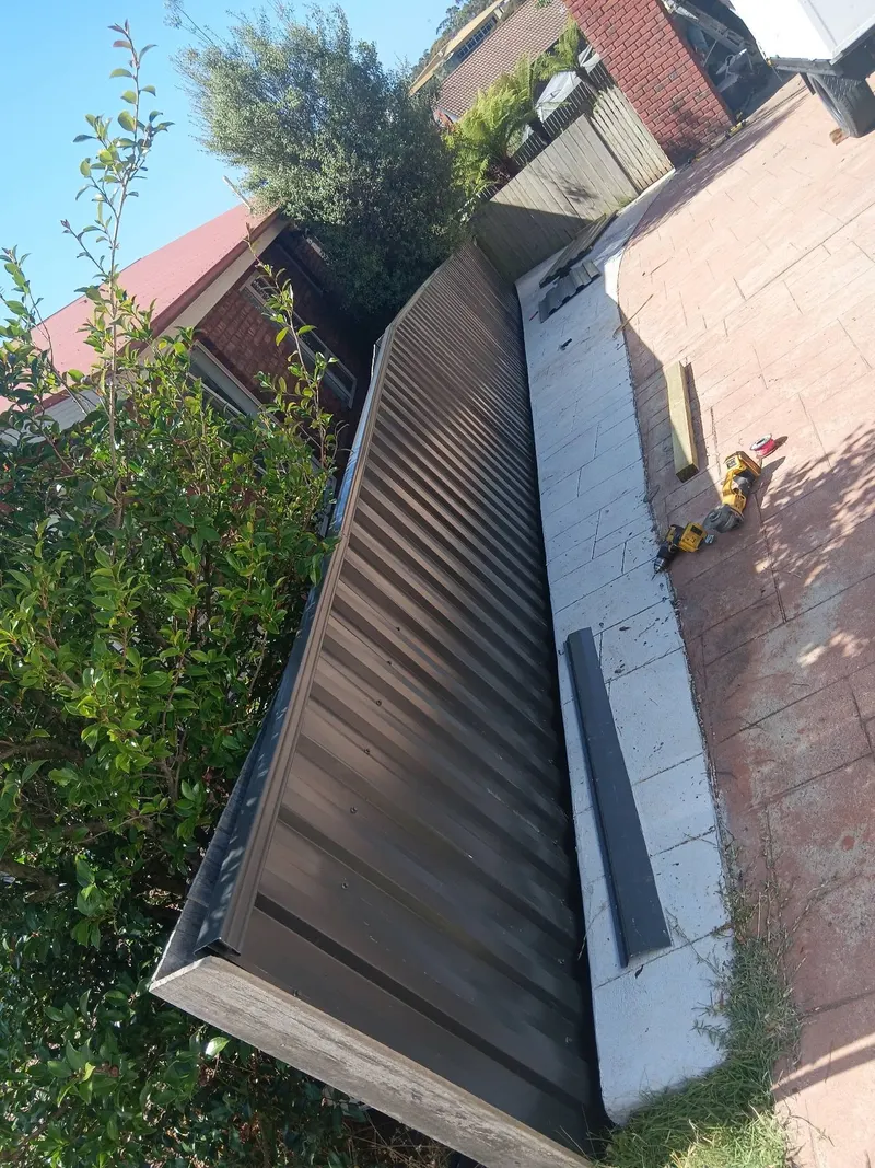 Colorbond fence stepping down beside garden steps