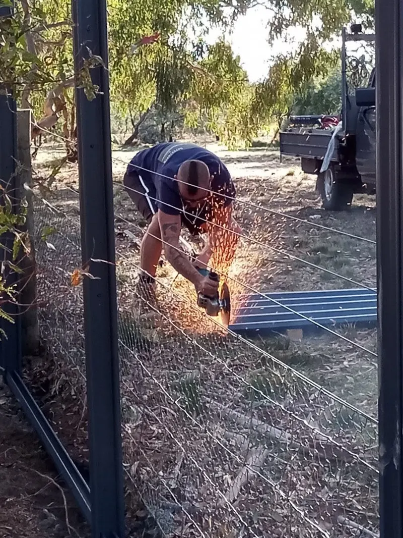 Cutting steel with an angle grinder on site, sparks flying