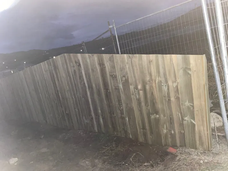 New timber fence photographed at dusk with hills behind